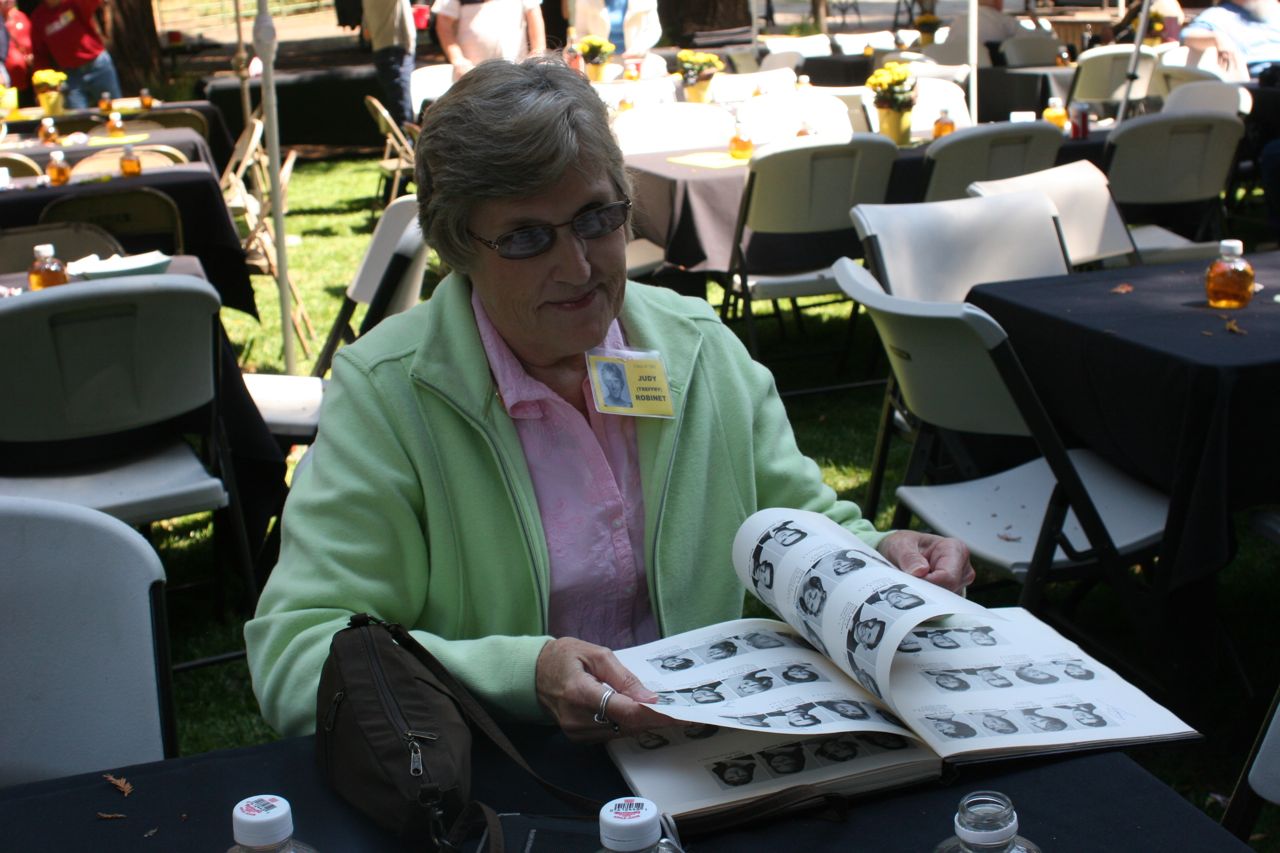 Judy (Treffry) Robinet looking at a Manzanita